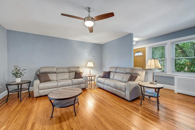 2524 Mickle Ave, Bronx, NY 10469 - living area featuring radiator, ceiling fan, and light wood-type flooring