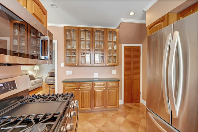 2524 Mickle Ave, Bronx, NY 10469 - kitchen with stainless steel appliances, crown molding, glass insert cabinets, dark countertops, and light tile patterned floors