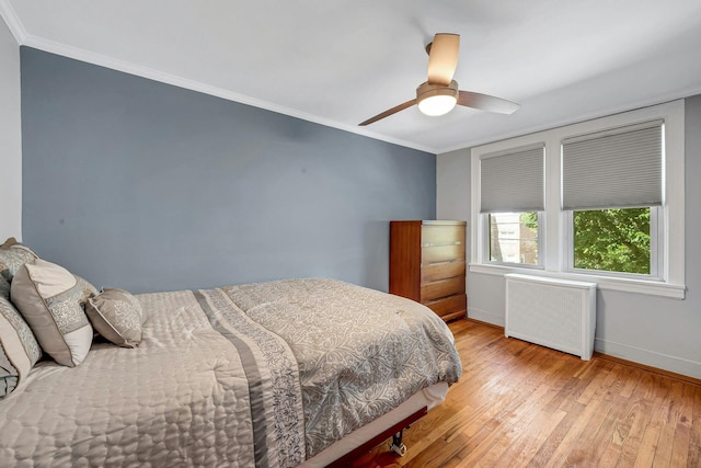 2524 Mickle Ave, Bronx, NY 10469 - bedroom with radiator heating unit, light wood finished floors, crown molding, and ceiling fan