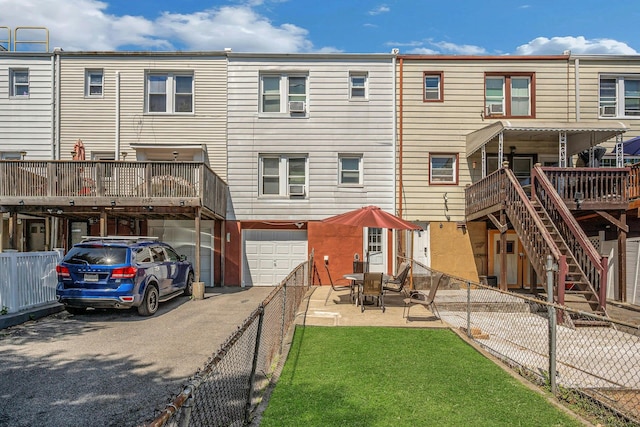 2524 Mickle Ave, Bronx, NY 10469 - rear view of house featuring driveway, a garage, a fenced backyard, stairs, and a deck