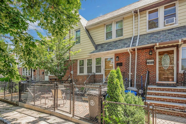 2524 Mickle Ave, Bronx, NY 10469 - view of property with brick siding, a high end roof, a gate, and a fenced front yard
