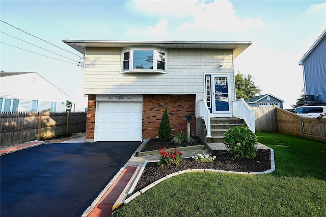 184 Sumpwams Ave, Babylon, NY 11702 - view of front of house featuring brick siding, asphalt driveway, and a garage