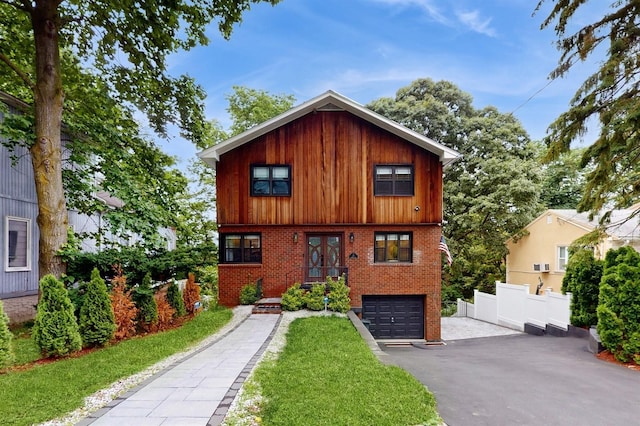 17 Arthur Pl, Yonkers, NY 10701 - view of front of home with brick siding, french doors, a garage, and driveway