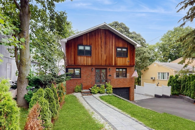 17 Arthur Pl, Yonkers, NY 10701 - view of front facade featuring driveway, french doors, brick siding, and a garage