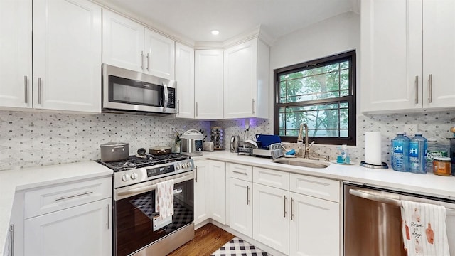 17 Arthur Pl, Yonkers, NY 10701 - kitchen with appliances with stainless steel finishes, light countertops, white cabinetry, tasteful backsplash, and recessed lighting