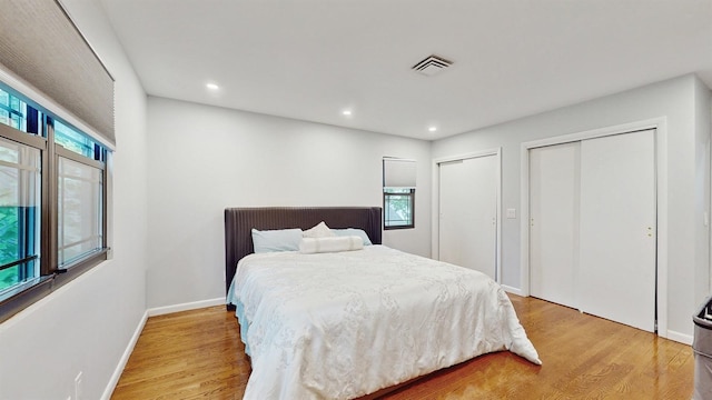 17 Arthur Pl, Yonkers, NY 10701 - bedroom featuring multiple closets, multiple windows, light wood finished floors, and recessed lighting