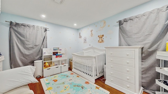 17 Arthur Pl, Yonkers, NY 10701 - bedroom featuring wood finished floors, recessed lighting, and a nursery area