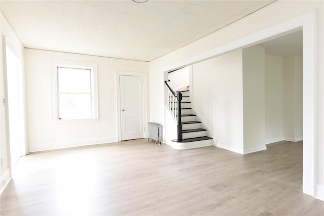 24 Parsons Dr, Hempstead, NY 11550 - foyer entrance with radiator, light wood-style floors, and stairway