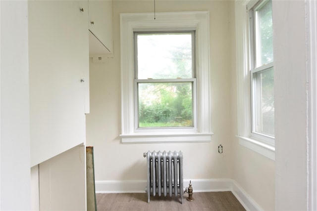 24 Parsons Dr, Hempstead, NY 11550 - empty room featuring radiator heating unit and wood finished floors