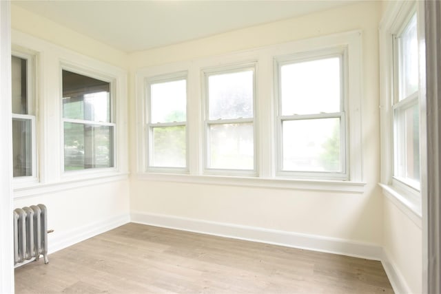 24 Parsons Dr, Hempstead, NY 11550 - unfurnished sunroom featuring radiator heating unit