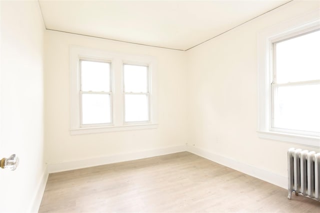 24 Parsons Dr, Hempstead, NY 11550 - unfurnished room featuring radiator and light wood-style flooring