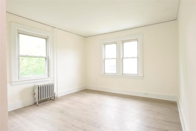 24 Parsons Dr, Hempstead, NY 11550 - unfurnished room with radiator heating unit and light wood-type flooring