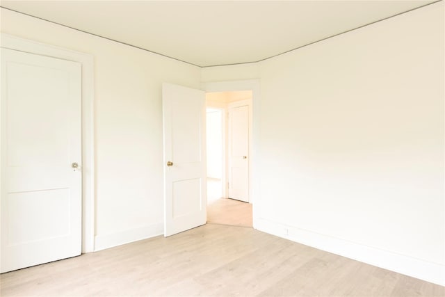 24 Parsons Dr, Hempstead, NY 11550 - unfurnished bedroom with light wood-style flooring and baseboards