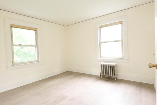 24 Parsons Dr, Hempstead, NY 11550 - spare room with radiator heating unit and light wood-style flooring
