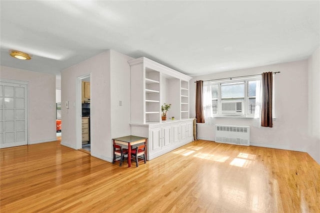 29-49 137th St Unit 2H, Flushing, NY 11354 - empty room with radiator heating unit, wood finished floors, and cooling unit