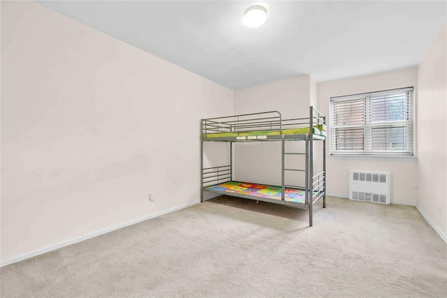 29-49 137th St Unit 2H, Flushing, NY 11354 - unfurnished bedroom with radiator and carpet flooring