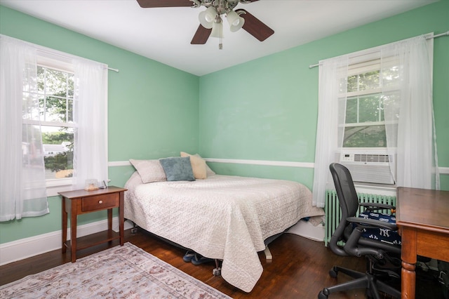 3665 Lufberry Ave, Wantagh, NY 11793 - bedroom featuring wood finished floors, cooling unit, radiator, and a ceiling fan