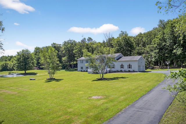 97 Pittaluga Dr, Monticello, NY 12701 - view of green lawn featuring asphalt driveway and a garage