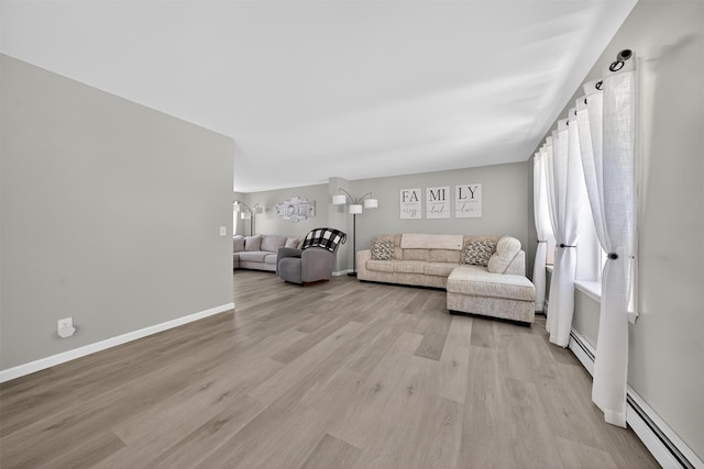 97 Pittaluga Dr, Monticello, NY 12701 - living area with a baseboard radiator and light wood-style flooring