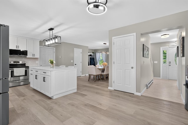 97 Pittaluga Dr, Monticello, NY 12701 - kitchen featuring appliances with stainless steel finishes, white cabinets, and light wood-style floors