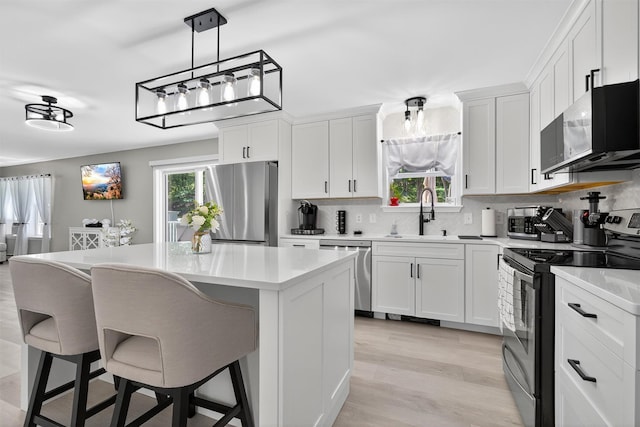 97 Pittaluga Dr, Monticello, NY 12701 - kitchen featuring stainless steel appliances, a center island, backsplash, and light countertops
