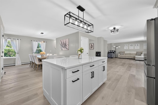 97 Pittaluga Dr, Monticello, NY 12701 - kitchen featuring open floor plan, white cabinetry, light wood-style flooring, and light countertops