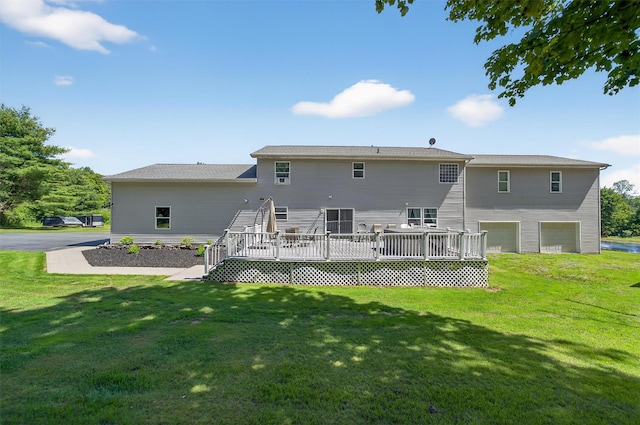 97 Pittaluga Dr, Monticello, NY 12701 - back of property with a garage, a wooden deck, and a lawn