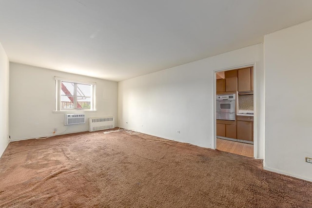 86-10 151st Unit 6B, Howard Beach, NY 11411 - spare room with radiator, carpet flooring, and an AC wall unit
