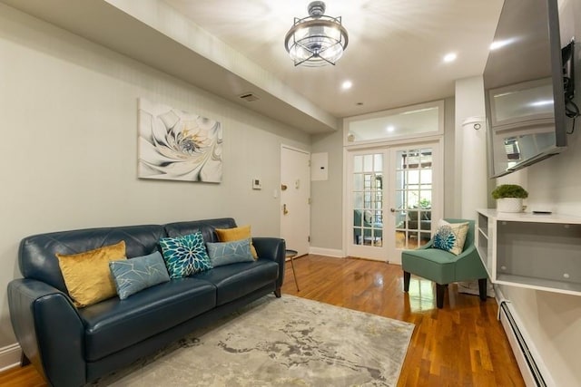 100 Ralph Ave Unit 2L, Brooklyn, NY 11221 - living area featuring a baseboard heating unit, wood finished floors, french doors, and recessed lighting
