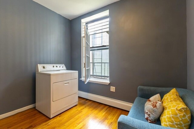 100 Ralph Ave Unit 2L, Brooklyn, NY 11221 - laundry room with washer / dryer, a baseboard radiator, and light wood-style flooring