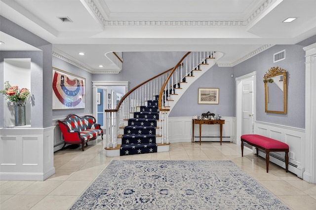 8 Danton Ln S, Locust Valley, NY 11560 - foyer entrance with tile patterned floors, stairway, a baseboard heating unit, crown molding, and a wainscoted wall