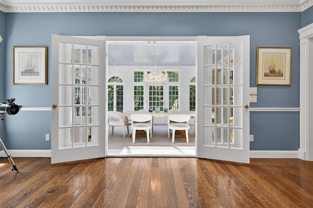 8 Danton Ln S, Locust Valley, NY 11560 - doorway to outside with a chandelier, wood finished floors, and ornamental molding