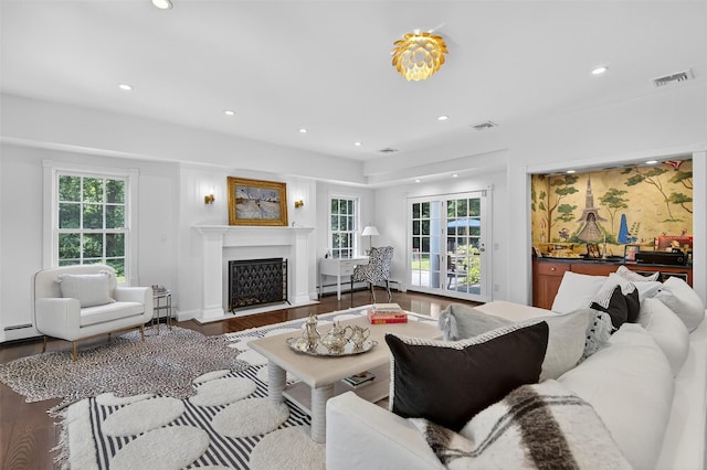 8 Danton Ln S, Locust Valley, NY 11560 - living room with plenty of natural light, recessed lighting, a fireplace with flush hearth, wood finished floors, and a baseboard heating unit