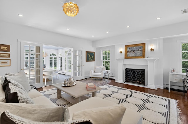 8 Danton Ln S, Locust Valley, NY 11560 - living room with a baseboard radiator, wood finished floors, healthy amount of natural light, a fireplace with flush hearth, and recessed lighting