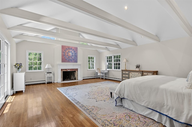 8 Danton Ln S, Locust Valley, NY 11560 - bedroom with multiple windows, a baseboard heating unit, wood finished floors, and a fireplace with flush hearth