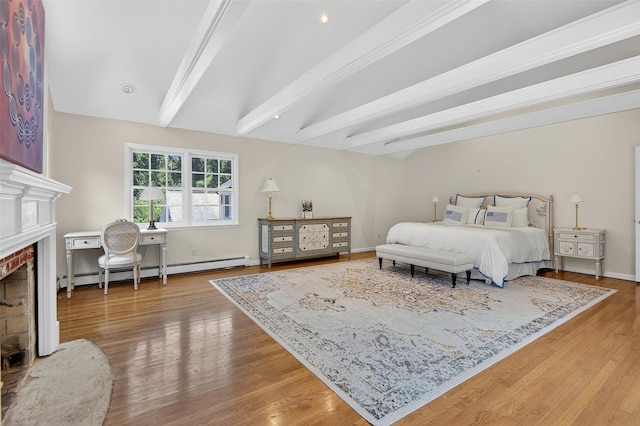 8 Danton Ln S, Locust Valley, NY 11560 - bedroom featuring a baseboard radiator, a brick fireplace, beamed ceiling, and wood finished floors