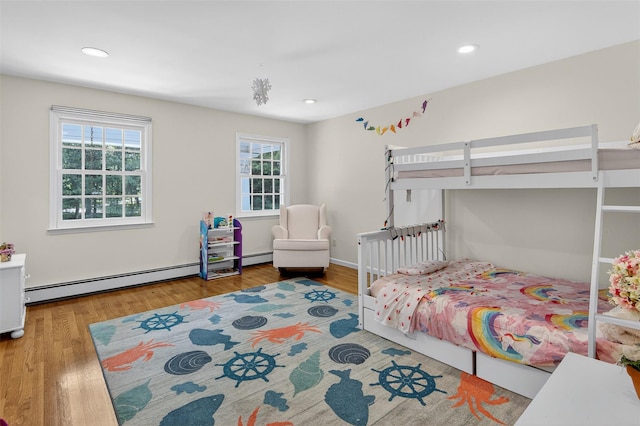 8 Danton Ln S, Locust Valley, NY 11560 - bedroom featuring wood finished floors, recessed lighting, and a baseboard heating unit
