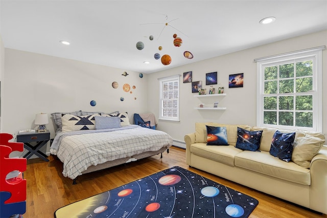 8 Danton Ln S, Locust Valley, NY 11560 - bedroom with wood finished floors, recessed lighting, and a baseboard heating unit