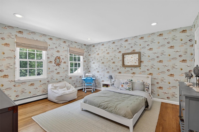 8 Danton Ln S, Locust Valley, NY 11560 - bedroom with a baseboard heating unit, wallpapered walls, wood finished floors, and recessed lighting