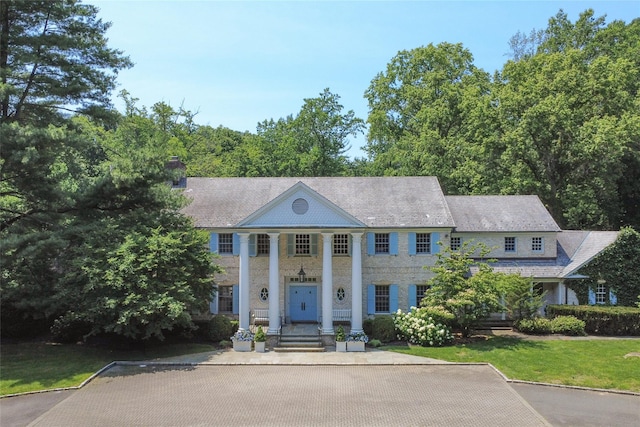 8 Danton Ln S, Locust Valley, NY 11560 - greek revival house featuring a chimney and a front yard