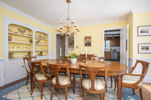 38 Mason Dr, Manhasset, NY 11030 - dining room featuring crown molding, a chandelier, a wainscoted wall, built in shelves, and light wood finished floors