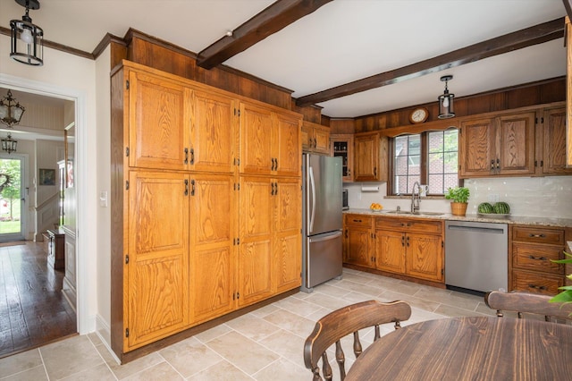 38 Mason Dr, Manhasset, NY 11030 - kitchen with appliances with stainless steel finishes, plenty of natural light, brown cabinets, beamed ceiling, and light countertops