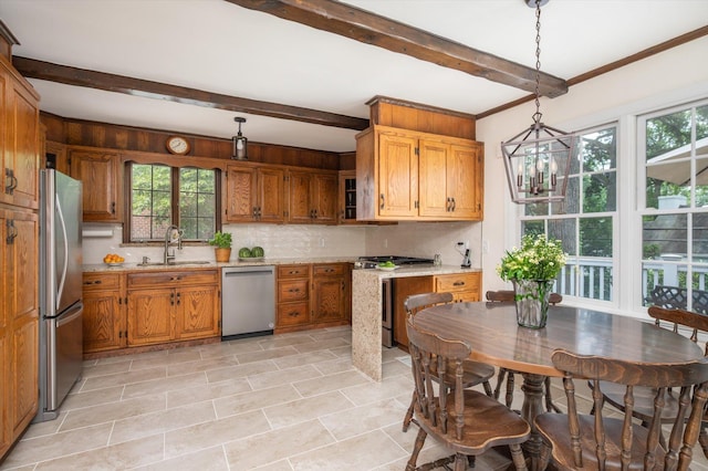 38 Mason Dr, Manhasset, NY 11030 - kitchen featuring appliances with stainless steel finishes, decorative backsplash, beamed ceiling, a chandelier, and brown cabinetry