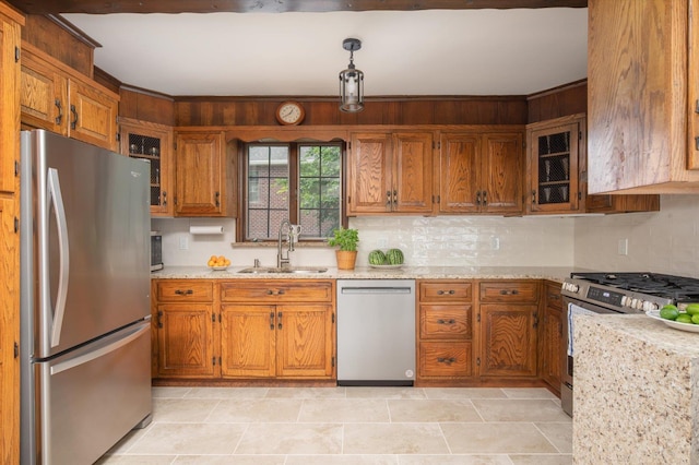 38 Mason Dr, Manhasset, NY 11030 - kitchen with stainless steel appliances, brown cabinetry, and backsplash