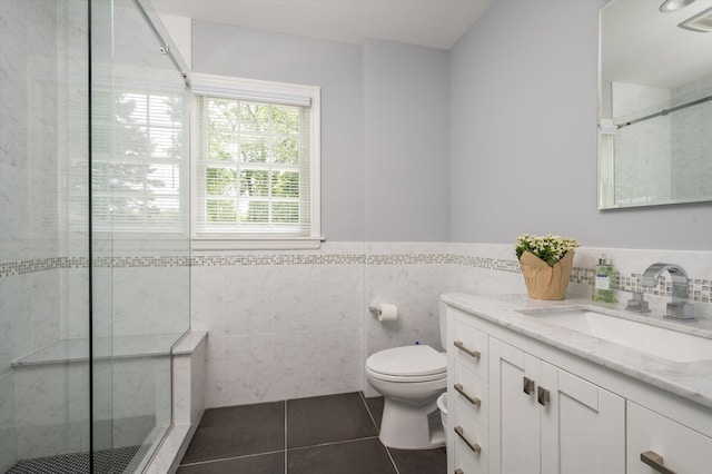 38 Mason Dr, Manhasset, NY 11030 - bathroom with tile walls, tile patterned floors, vanity, a stall shower, and wainscoting
