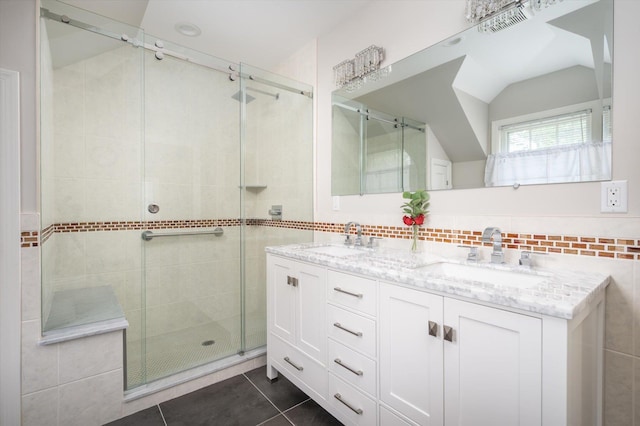 38 Mason Dr, Manhasset, NY 11030 - bathroom featuring double vanity, a stall shower, tile patterned flooring, vaulted ceiling, and decorative backsplash