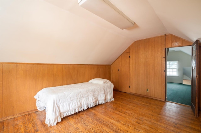 38 Mason Dr, Manhasset, NY 11030 - bedroom featuring lofted ceiling, wood finished floors, and wood walls