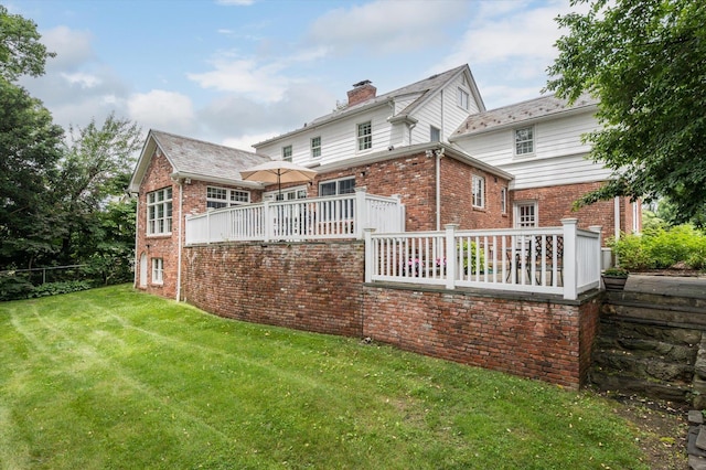 38 Mason Dr, Manhasset, NY 11030 - back of house featuring brick siding, a chimney, and a wooden deck