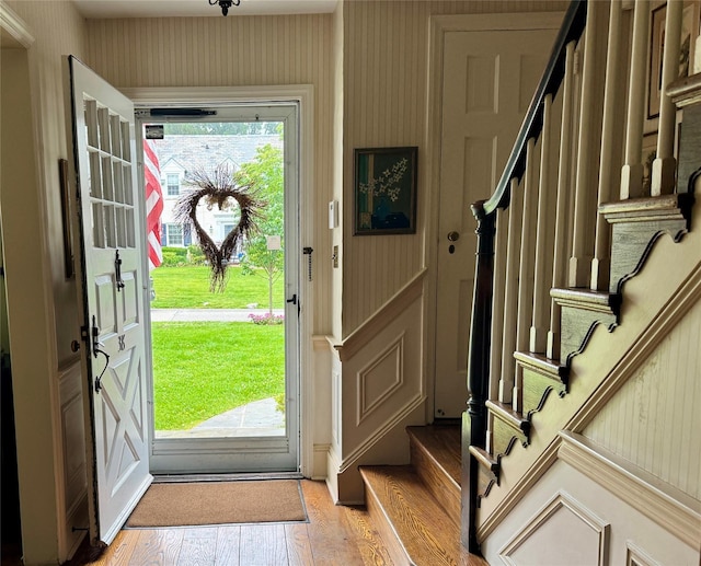 38 Mason Dr, Manhasset, NY 11030 - foyer with stairs, wallpapered walls, and light wood finished floors