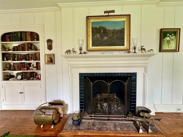 38 Mason Dr, Manhasset, NY 11030 - detailed view of a decorative wall, a fireplace, wood finished floors, and built in features